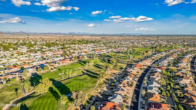 drone / aerial view featuring a residential view, a mountain view, and view of golf course