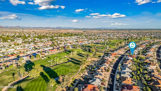 aerial view with a residential view, a mountain view, and view of golf course