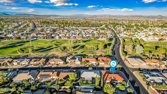 aerial view with a residential view, a mountain view, and golf course view