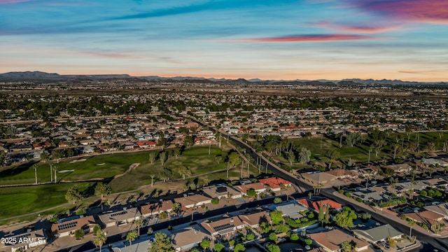 drone / aerial view with a residential view, a mountain view, and golf course view