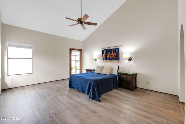 bedroom featuring ceiling fan, wood finished floors, and high vaulted ceiling