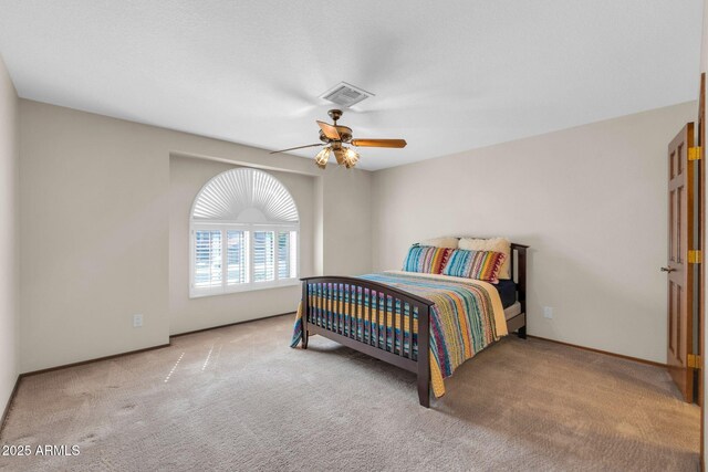 bedroom with baseboards, carpet, visible vents, and ceiling fan