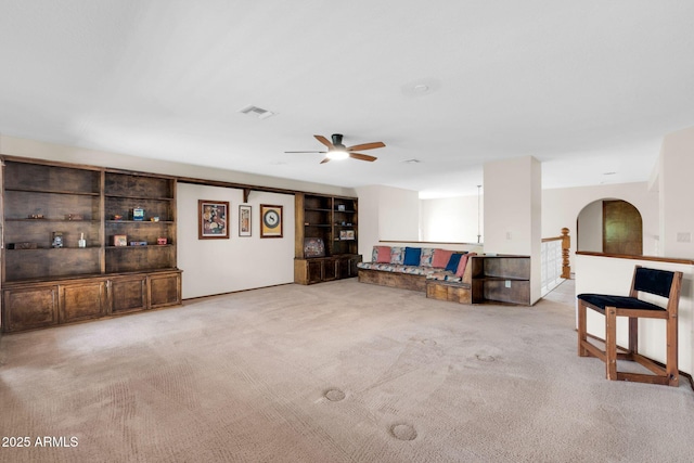 unfurnished living room with carpet flooring, visible vents, and ceiling fan