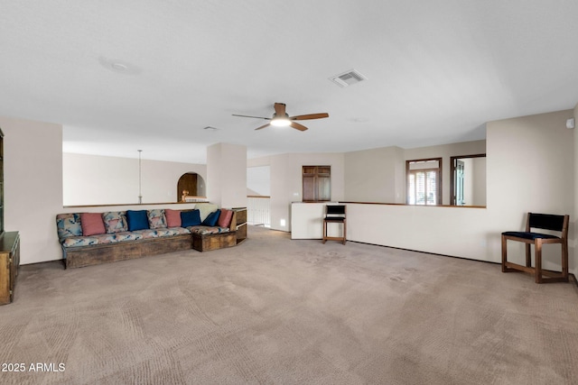 living area with visible vents, carpet flooring, and a ceiling fan