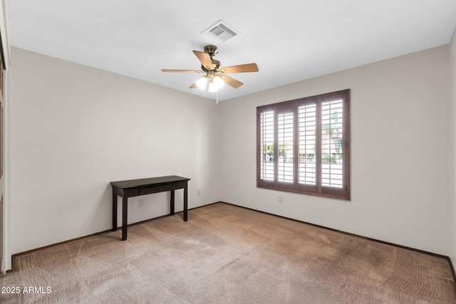 spare room featuring visible vents, carpet floors, and a ceiling fan