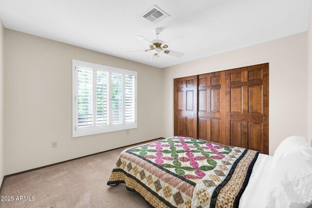 bedroom with a ceiling fan, baseboards, visible vents, carpet floors, and a closet