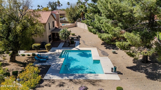 pool with a patio and a fenced backyard