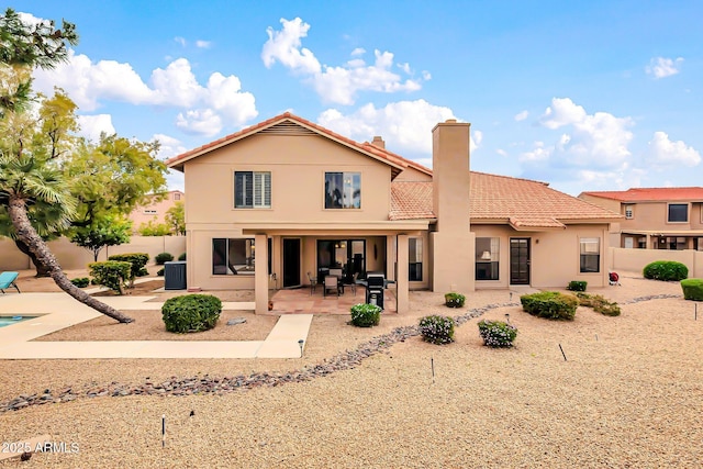 rear view of property with stucco siding, a patio, fence, and a tile roof