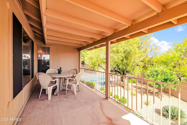 view of patio with outdoor dining area and fence