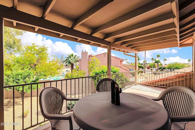 exterior space featuring a balcony and outdoor dining area