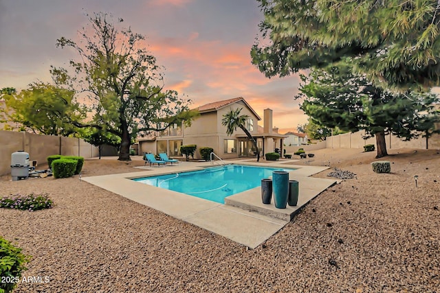 view of pool featuring a fenced backyard, a fenced in pool, and a patio