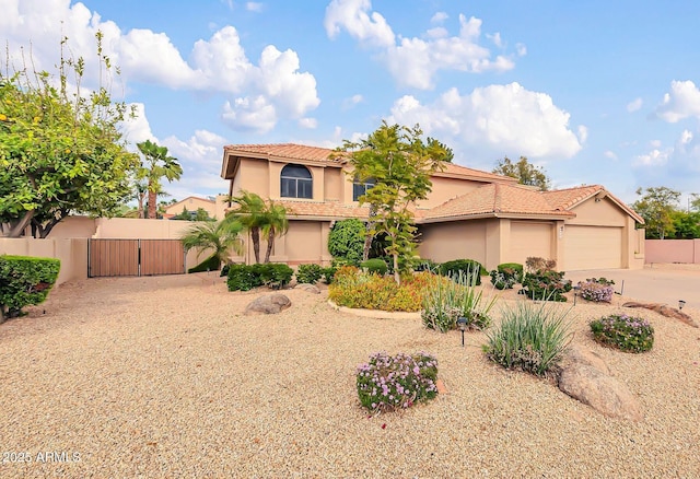 mediterranean / spanish-style home featuring stucco siding, a tile roof, a garage, and fence