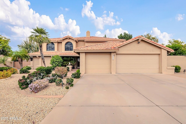 mediterranean / spanish-style home with an attached garage, a chimney, stucco siding, concrete driveway, and a tiled roof