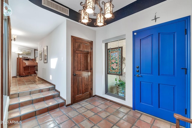 foyer entrance featuring a notable chandelier
