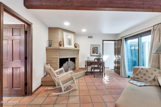living room with a fireplace and tile patterned floors