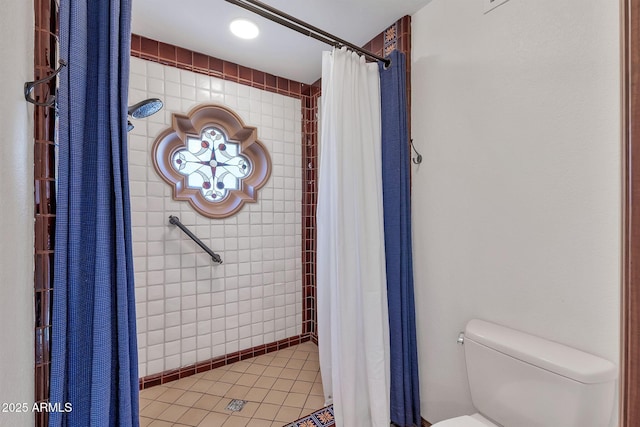 bathroom with tile patterned flooring, curtained shower, and toilet