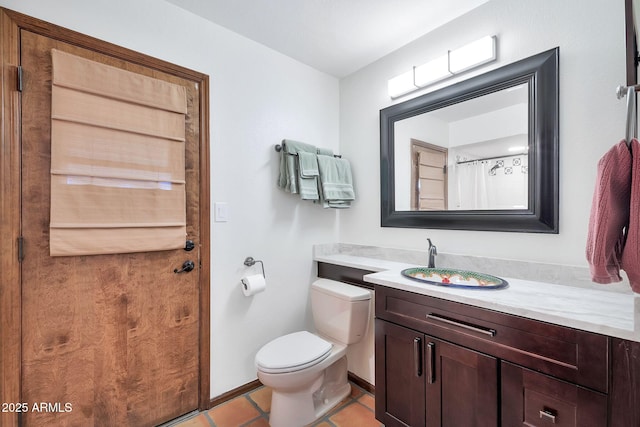 bathroom featuring toilet, vanity, and tile patterned floors