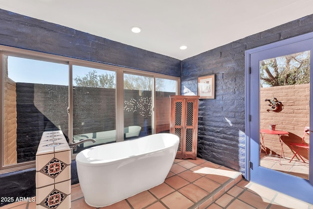 bathroom featuring tile patterned flooring and a washtub