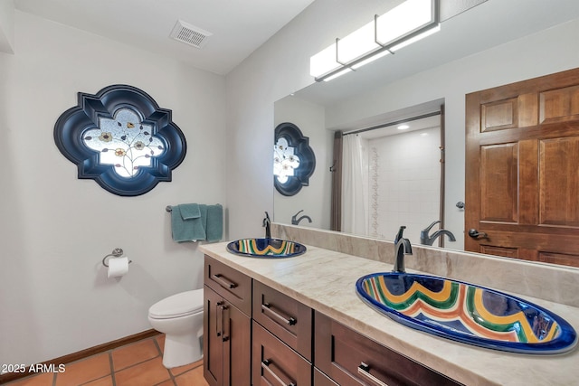 bathroom featuring tile patterned floors, vanity, curtained shower, and toilet