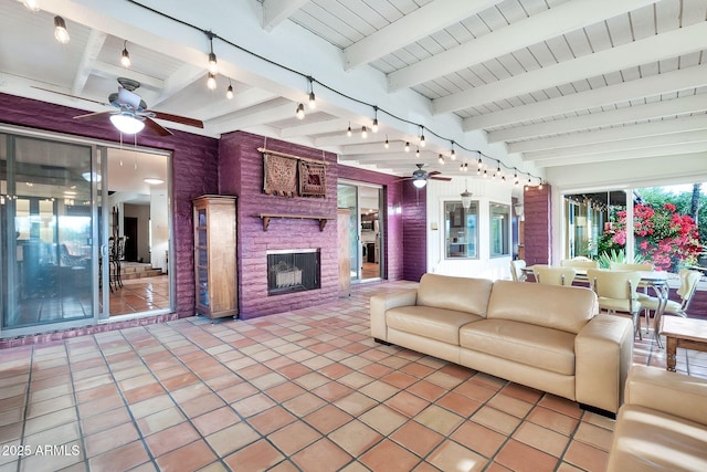 interior space featuring an outdoor living space with a fireplace and ceiling fan