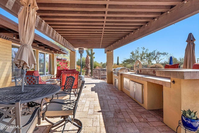 view of patio / terrace with an outdoor kitchen, sink, and grilling area