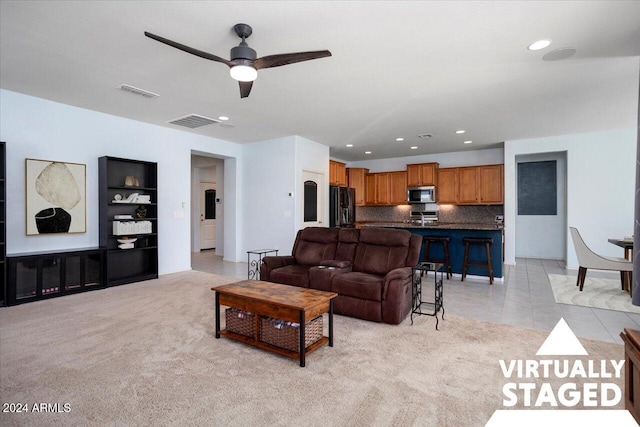 living room with ceiling fan and light tile patterned floors