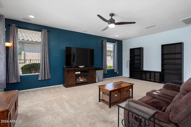 carpeted living room with ceiling fan