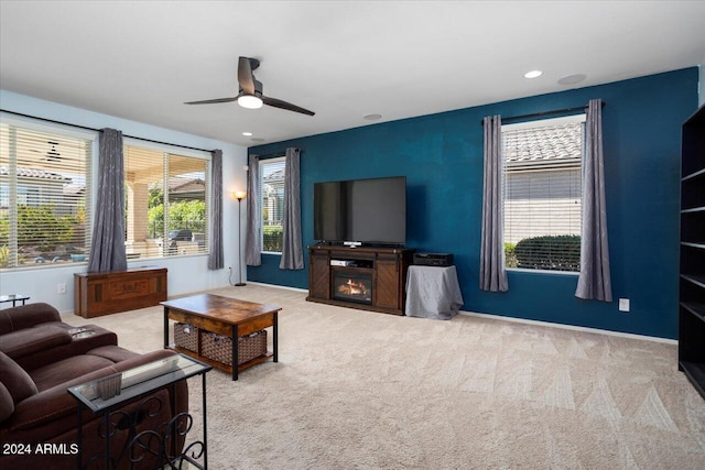 carpeted living room with ceiling fan