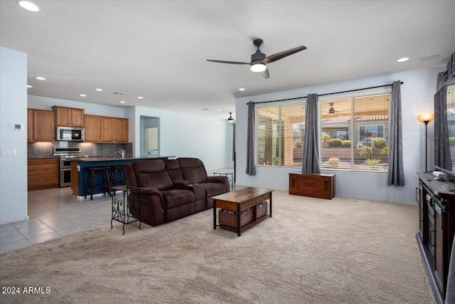 living room with light carpet and ceiling fan