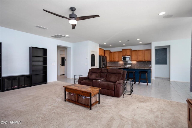 carpeted living room featuring ceiling fan