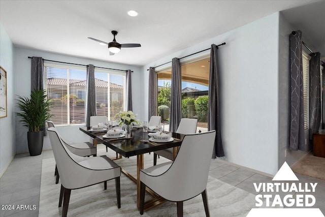 dining area with light tile patterned floors, a healthy amount of sunlight, and ceiling fan