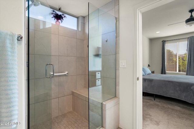 bathroom with a shower with door and ceiling fan