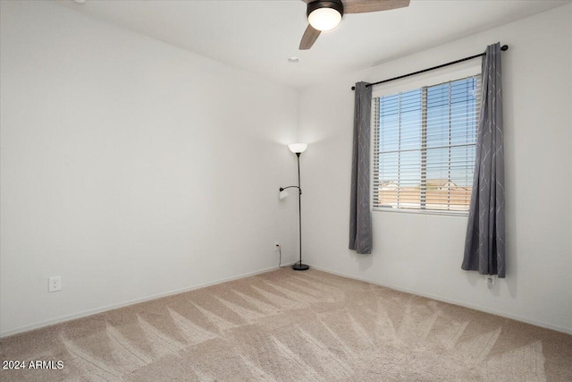 spare room with carpet and ceiling fan