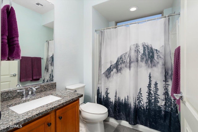 bathroom featuring toilet, curtained shower, and vanity