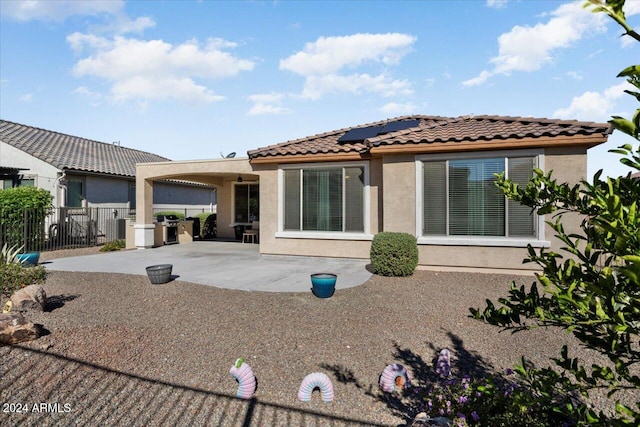 rear view of property featuring a patio