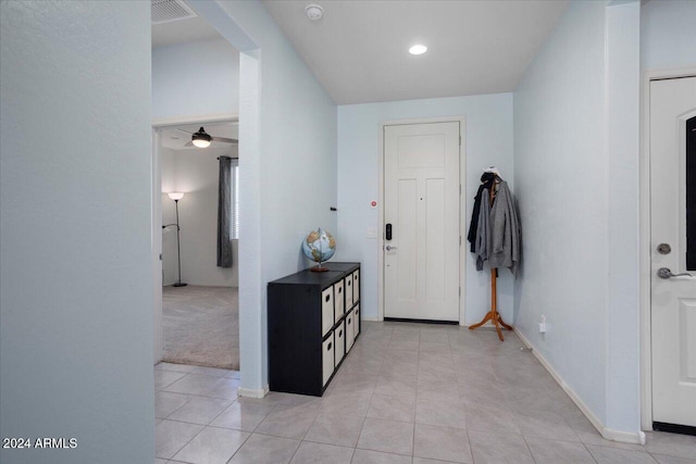 entrance foyer with light carpet and ceiling fan