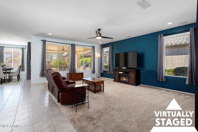 living room featuring light tile patterned floors, a wealth of natural light, and ceiling fan