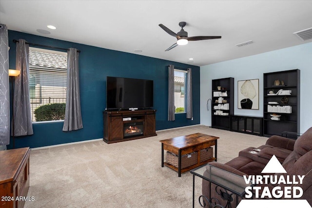 living room with light colored carpet and ceiling fan