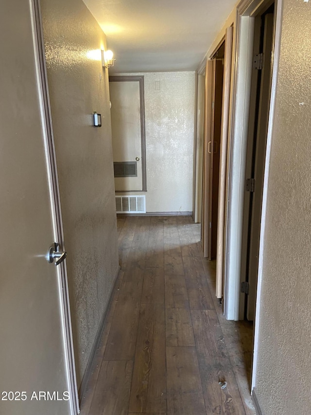 hallway with dark wood-type flooring