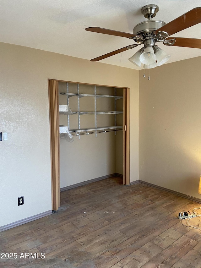 unfurnished bedroom featuring a closet, ceiling fan, and wood-type flooring