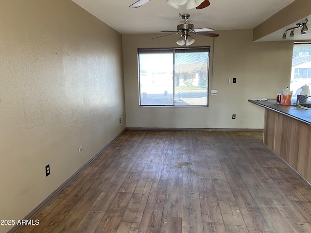 unfurnished dining area with a wealth of natural light, wood-type flooring, and sink