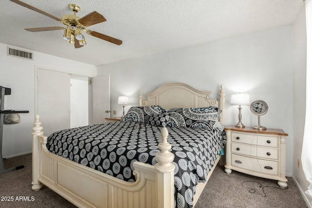 bedroom with a textured ceiling, carpet, and visible vents