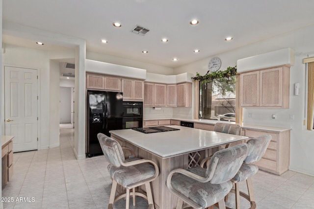 18 E Paint Your Wagon Trl, Phoenix, AZ 85085 - kitchen with black appliances, light brown cabinets, recessed lighting, a breakfast bar, and a center island