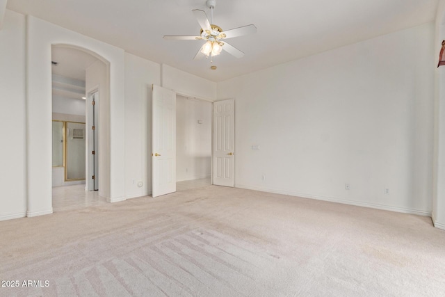 18 E Paint Your Wagon Trl, Phoenix, AZ 85085 - unfurnished bedroom featuring light colored carpet, arched walkways, baseboards, and a ceiling fan