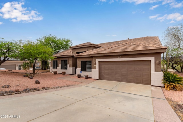 18 E Paint Your Wagon Trl, Phoenix, AZ 85085 - prairie-style home with concrete driveway, an attached garage, and stucco siding