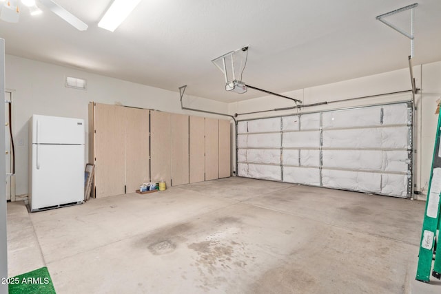 18 E Paint Your Wagon Trl, Phoenix, AZ 85085 - garage with freestanding refrigerator and a garage door opener