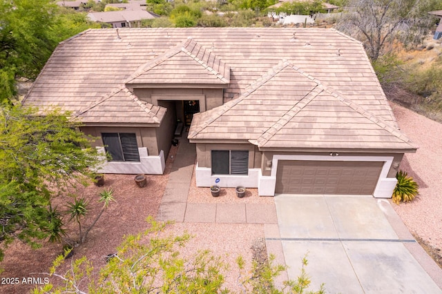 18 E Paint Your Wagon Trl, Phoenix, AZ 85085 - view of front facade featuring stucco siding, an attached garage, and concrete driveway