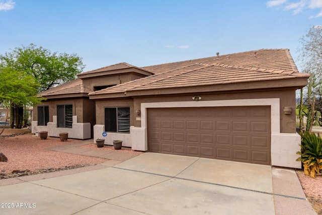 18 E Paint Your Wagon Trl, Phoenix, AZ 85085 - view of front of house featuring stucco siding, a garage, concrete driveway, and a tiled roof