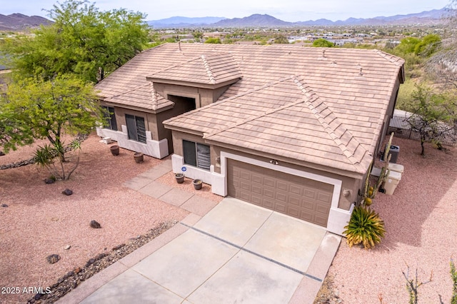 18 E Paint Your Wagon Trl, Phoenix, AZ 85085 - view of front facade with stucco siding, a mountain view, driveway, and a tile roof