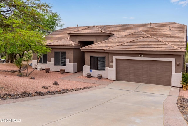 18 E Paint Your Wagon Trl, Phoenix, AZ 85085 - view of front facade with stucco siding, concrete driveway, an attached garage, and a tiled roof